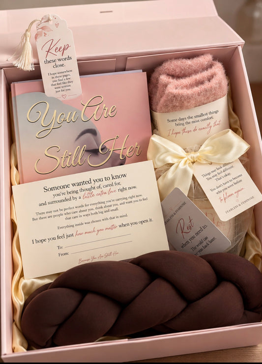 Close-up of the Still Her Box with a keepsake bookmark, comfort socks and a personal note