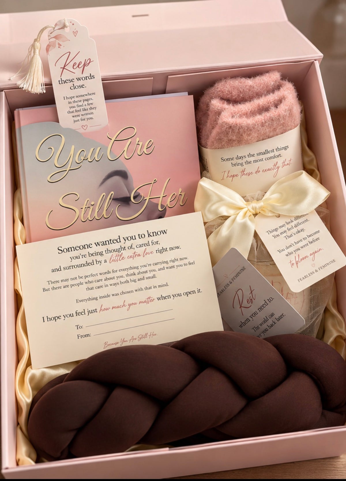 Close-up of the Still Her Box with a keepsake bookmark, comfort socks and a personal note